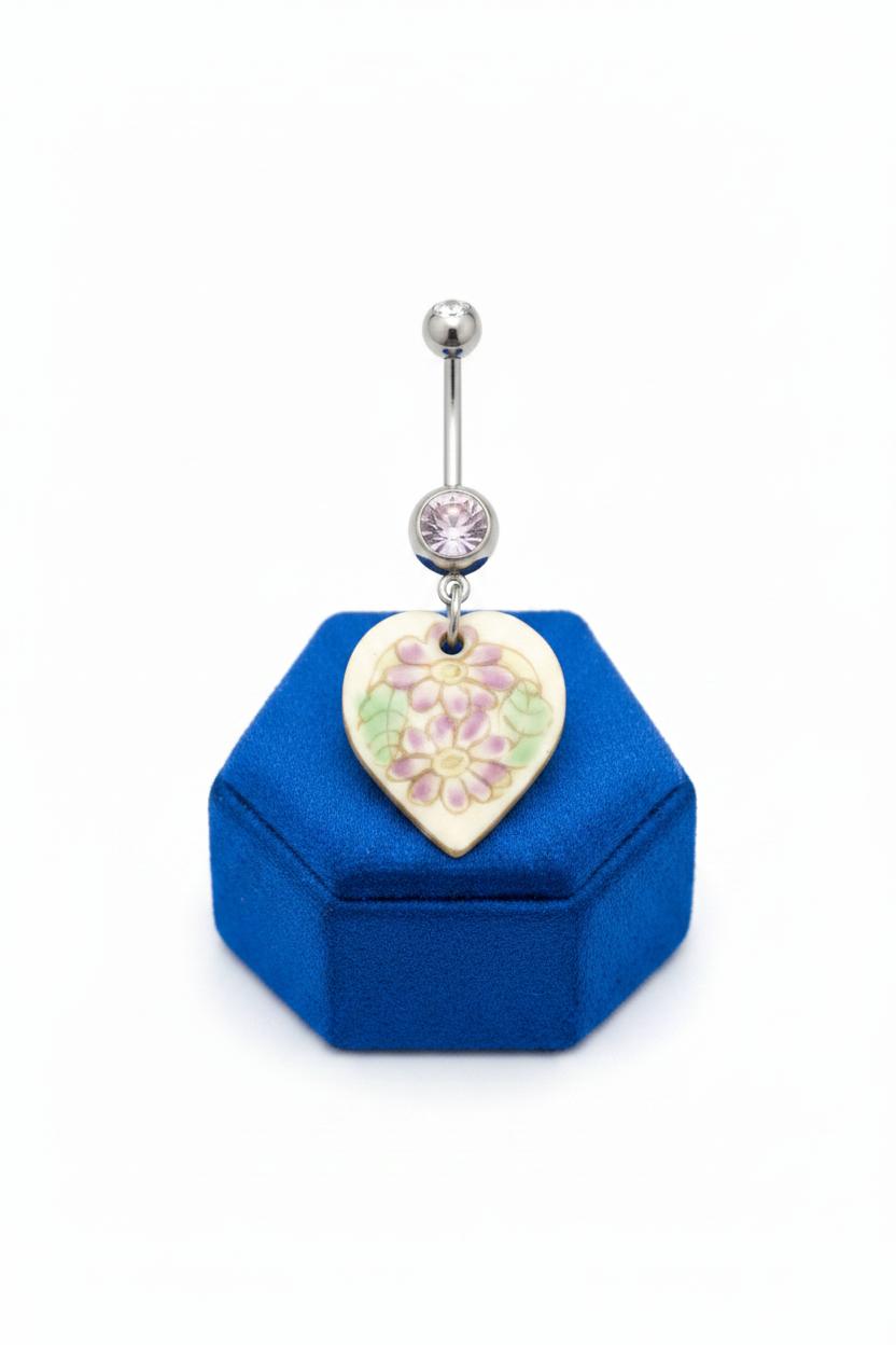 Purple Crystal Floral Heart Belly Button Ring in 316l stainless steel on a blue velvet jewelry display.