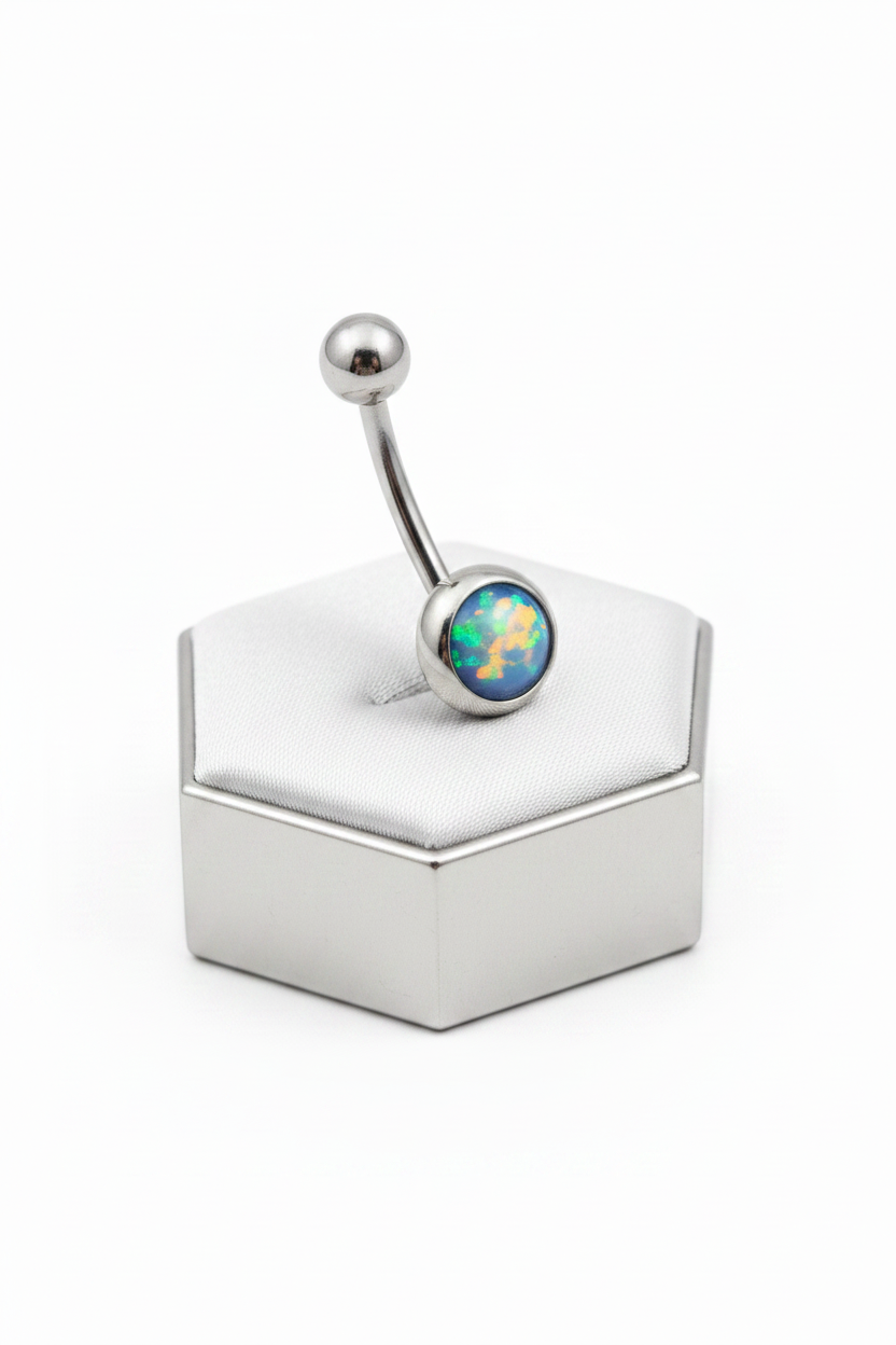 Navy Opal Belly Button Ring in 316l stainless steel on a silver jewelry display.