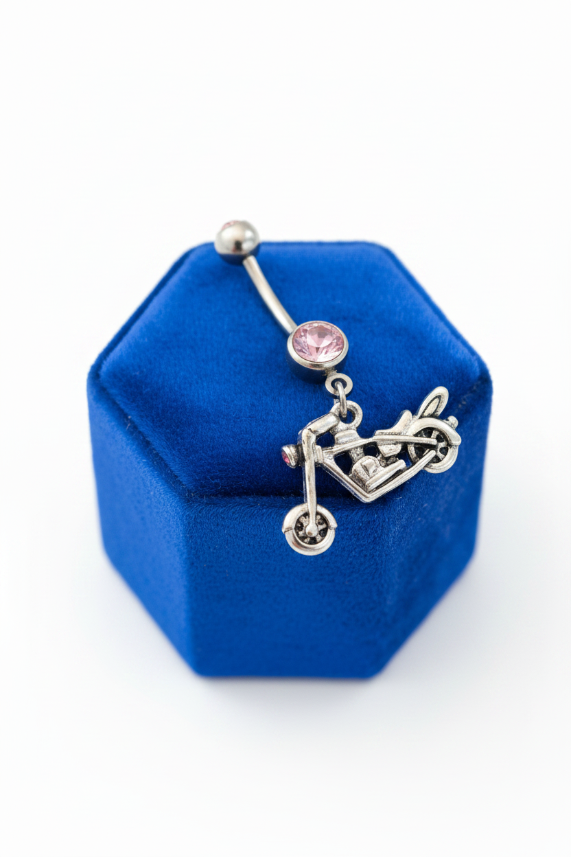 Pink Crystal Motorcycle Belly Button Ring in 316l stainless steel on a blue velvet jewelry display.