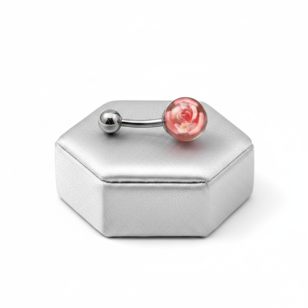 Pink Rose Acrylic Belly Button Ring in 316l stainless steel on a silver jewelry display.