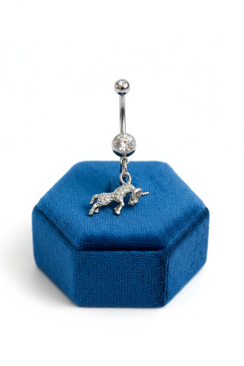 Clear Crystal Aries Belly Button Ring in 316l stainless steel on a blue velvet jewelry display.