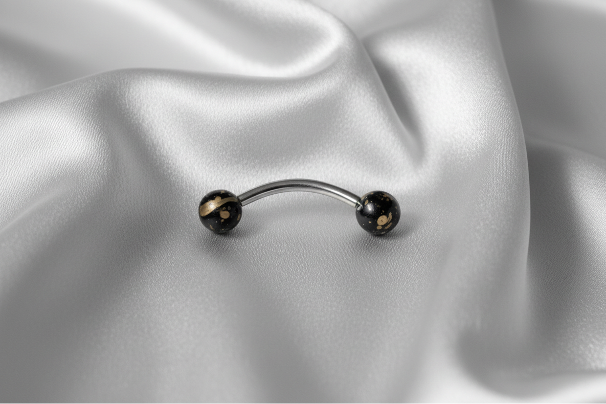 Black Gold Speckled Acrylic Eyebrow Ring in 316l stainless steel.