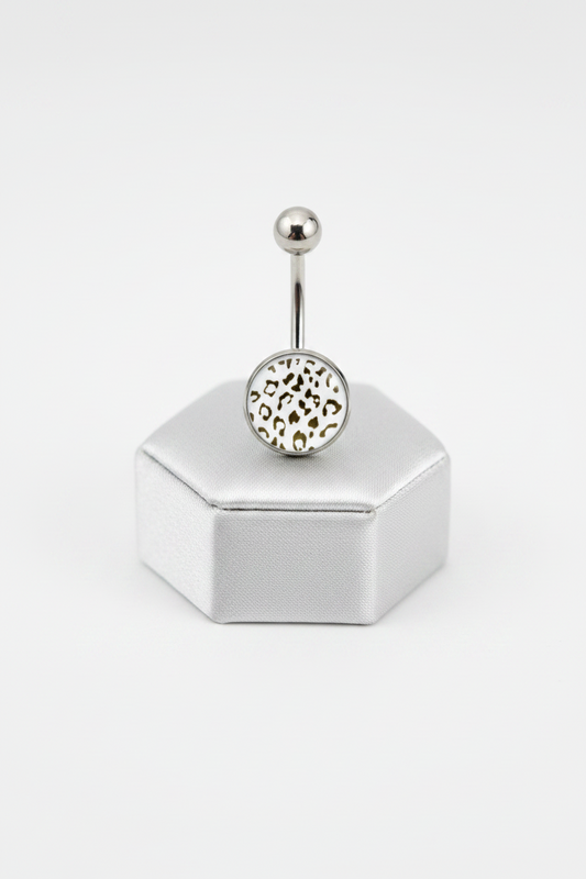 White Leopard Print Belly Button Ring in 316l stainless steel on a silver jewelry display.