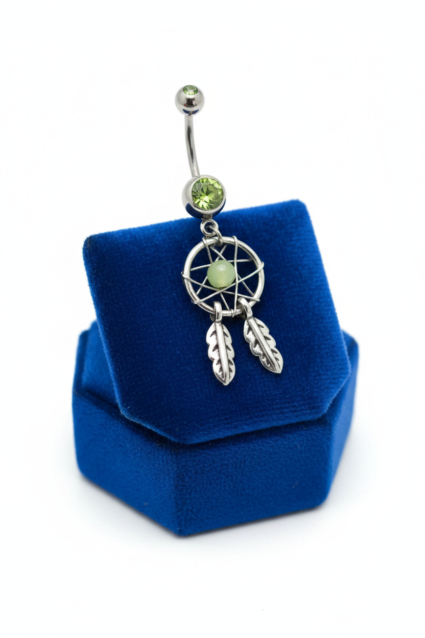 Green Crystal Mystical Dream Catcher Belly Button Ring in 316l stainless steel on a blue velvet jewelry display.