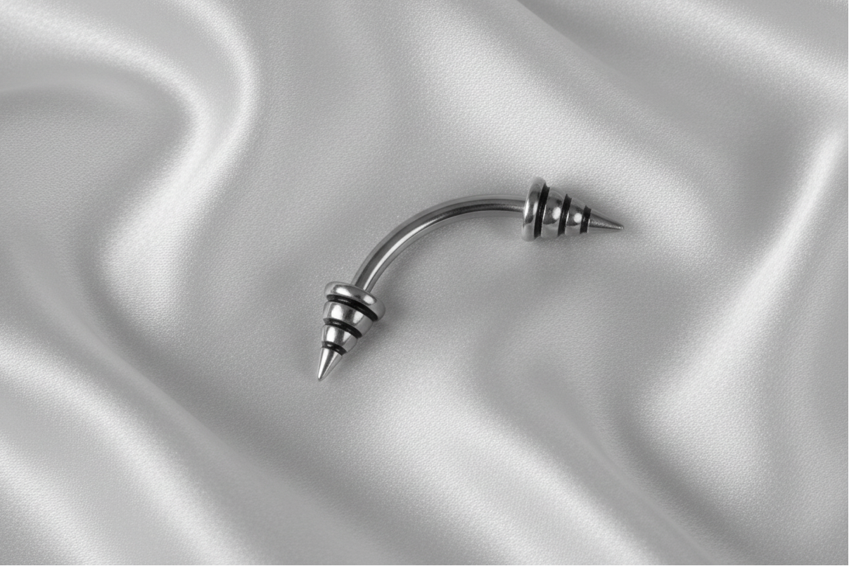 Black Striped Steel Spike Eyebrow Ring in 316l stainless steel.