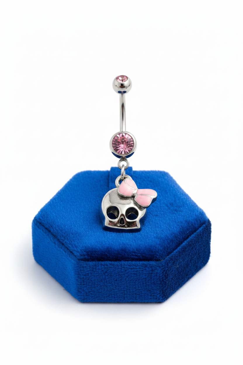 Pink Crystal Skull Belly Button Ring in 316l stainless steel on a blue velvet jewelry display.