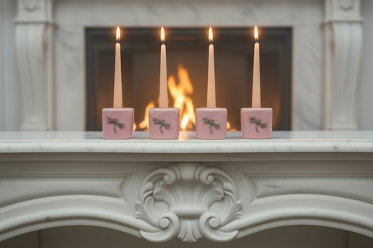 Pink Dragonfly Ceramic Mini Candle Holder Set of Four on the mantle of a fireplace with candles lit showing a warm glow.