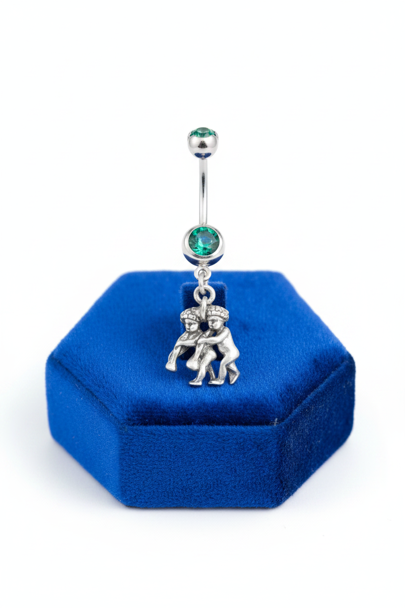 Green Crystal Gemini Belly Button Ring in 316l Stainless Steel on a blue velvet jewelry display.