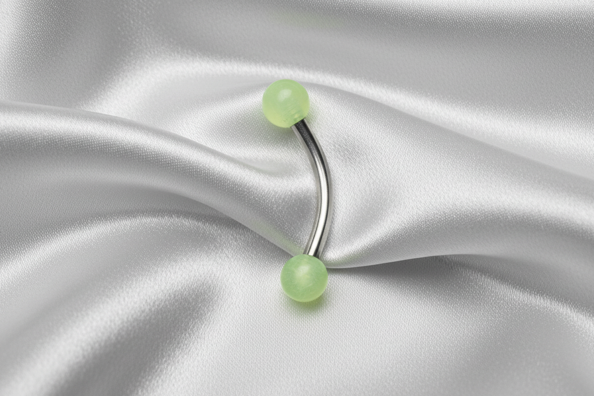 Yellow Glow Ball Acrylic Eyebrow Ring in 316l stainless steel.