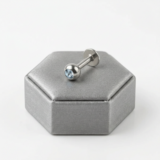 Sky Blue Crystal Labret Lip Ring in 316l stainless steel on a silver silk jewelry display.