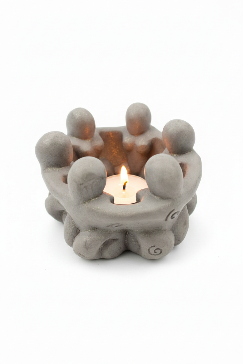 Circle of Goddesses Terra Cotta Tea Light Candle Holder on a white background.