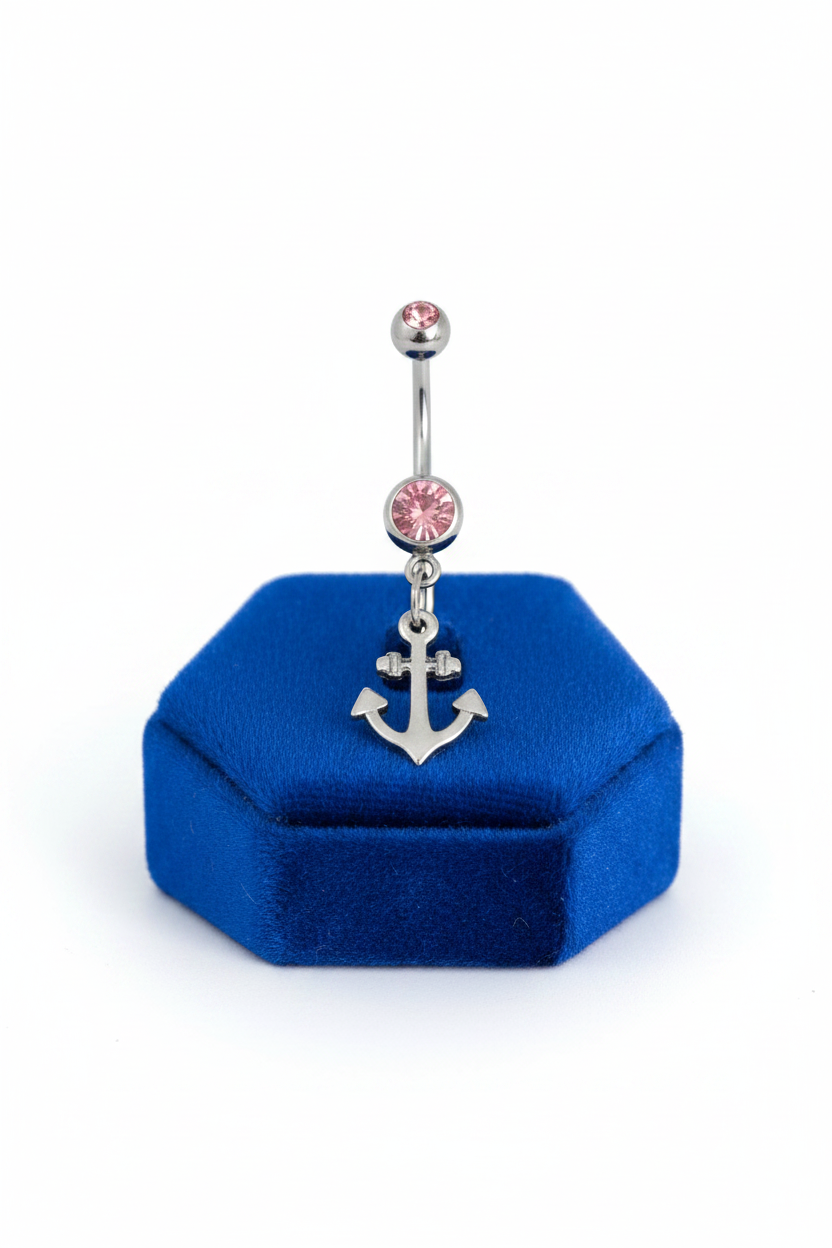 Pink Crystal Dainty Anchor Belly Button Ring in 316l stainless steel on a blue velvet jewelry display.