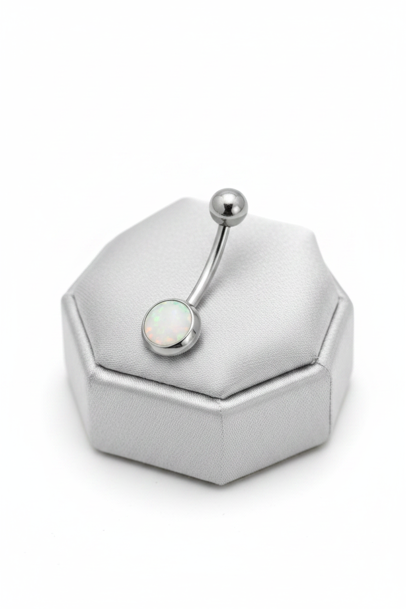 White Opal Belly Button Ring in 316l stainless steel on a sliver jewelry display.