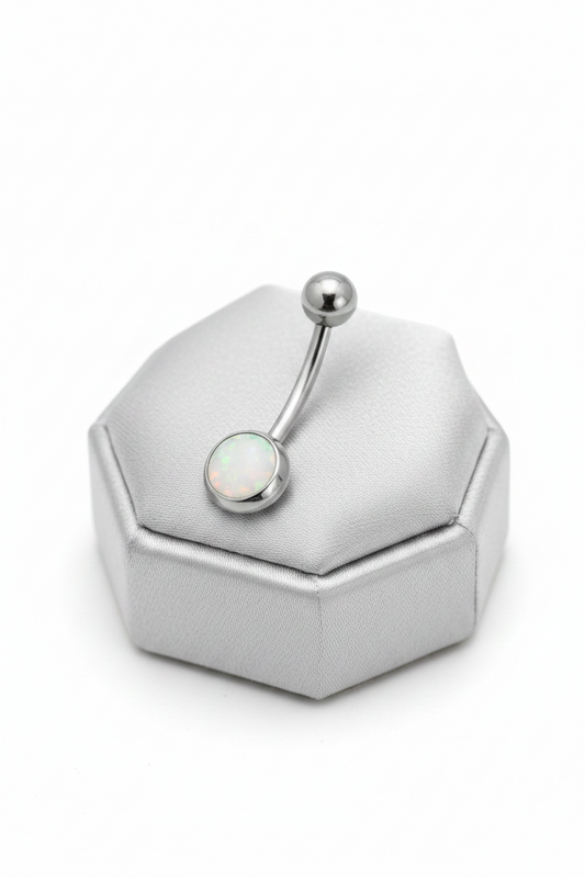 White Opal Belly Button Ring in 316l stainless steel on a sliver jewelry display.