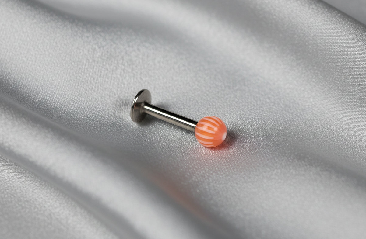 Orange & White Acrylic Labret Lip Ring in 316l stainless steel angled right.