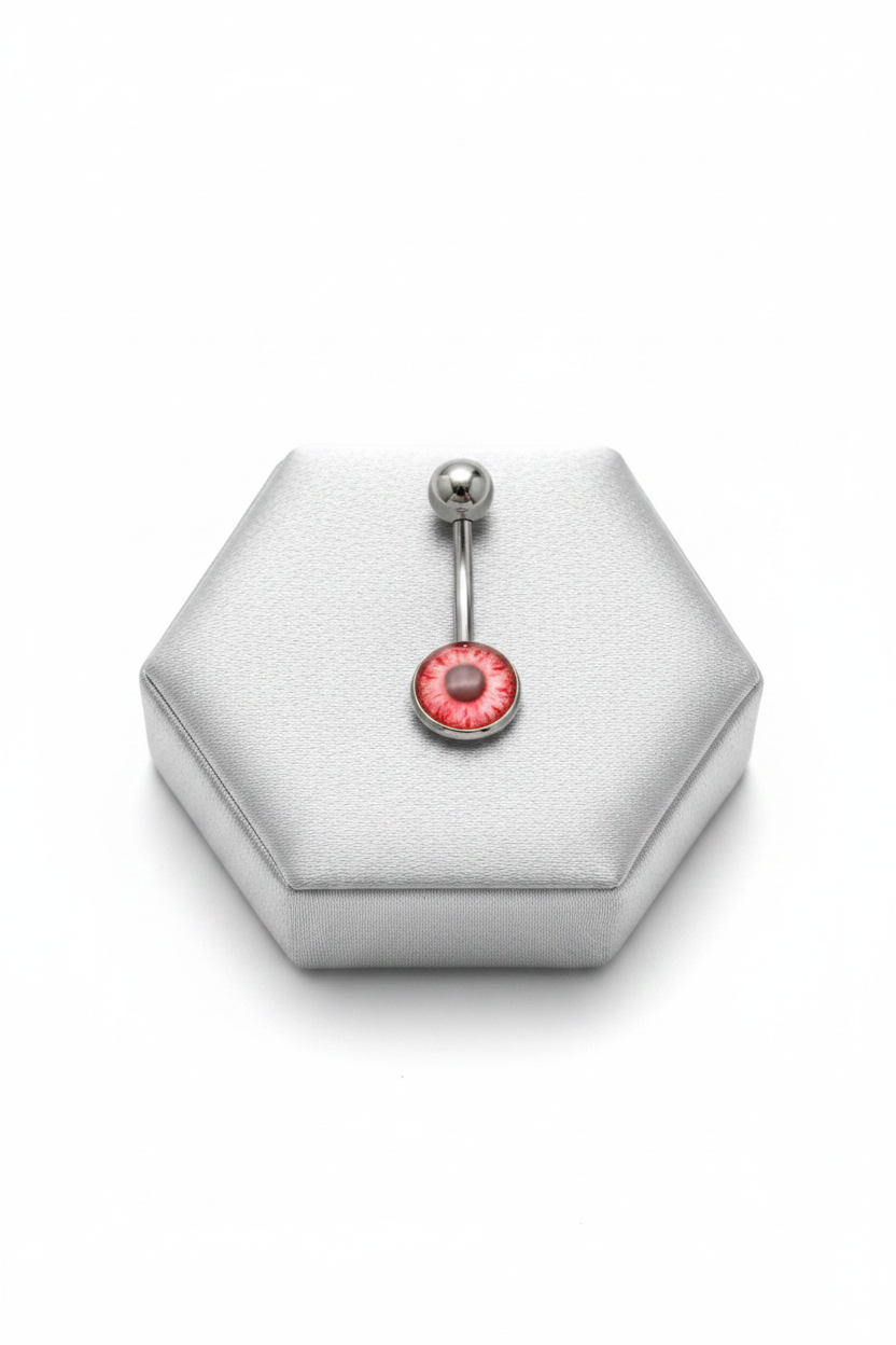 Red Eyeball Belly Button Ring in 316l stainless steel on a silver jewelry display.