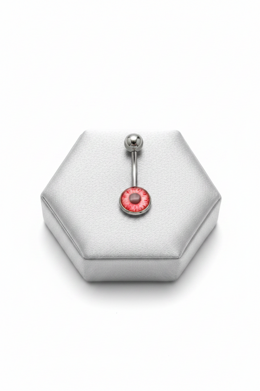 Red Eyeball Belly Button Ring in 316l stainless steel on a silver jewelry display.