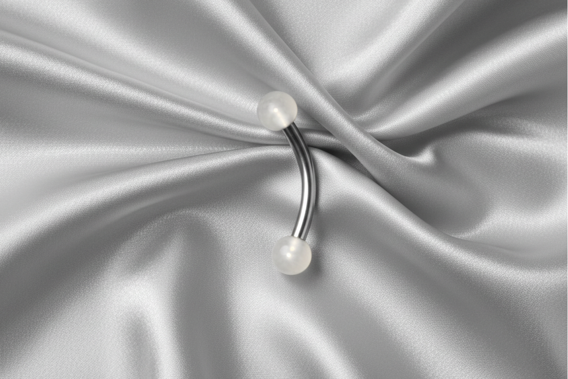 White Glow Ball Acrylic Eyebrow Ring in 316l stainless steel.