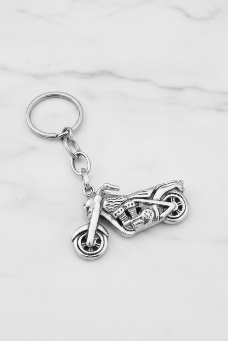 Motorcycle Handmade 316L Stainless Steel Charm Keychain on a white marble surface.