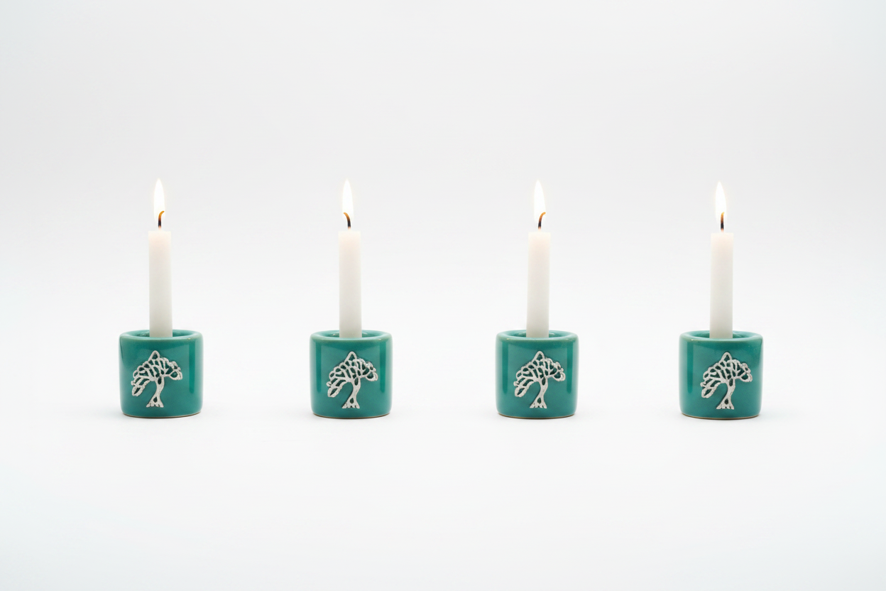 Green Tree of Life Ceramic Mini Candle Holder Set of Four on a white background with candles lit showing a warm glow.