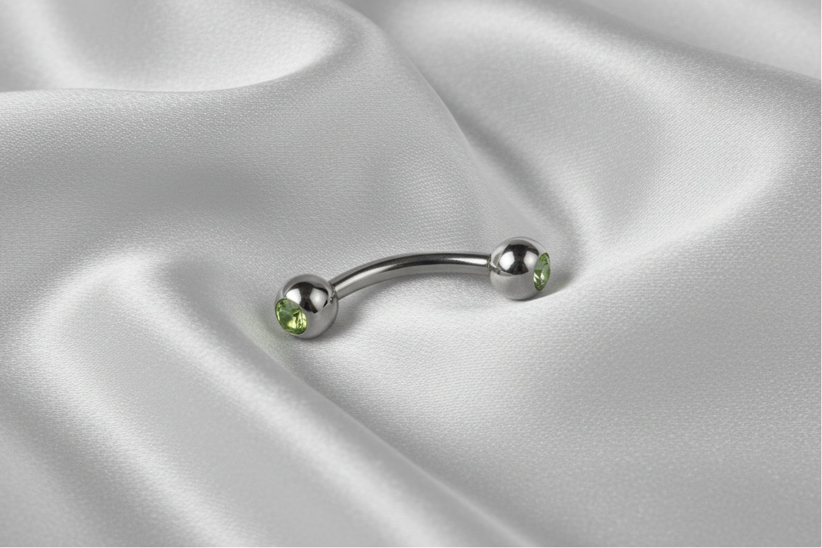Green Crystal Eyebrow Ring in 316l stainless steel.