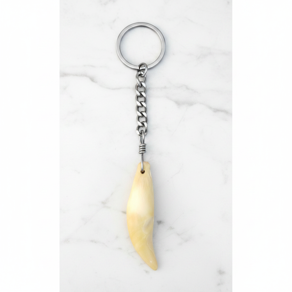 Authentic N.S Bear Tooth Handmade Steel Plated Keychain on a white marble surface.