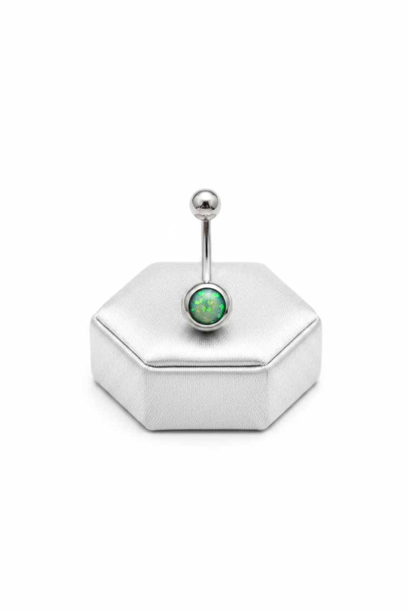 Green Opal Belly Button Ring in 316l stainless steel on a silver silk jewelry display upright position.