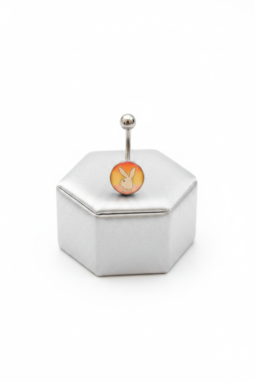 Rainbow Bunny Belly Button Ring in 316l stainless steel on a silver jewelry display.