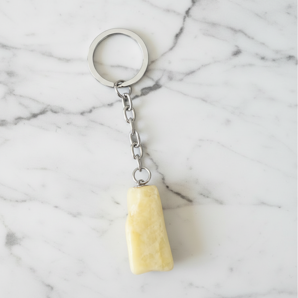 White Agate Natural Earth Stone Handmade Steel Plated Keychain on a white marble surface.