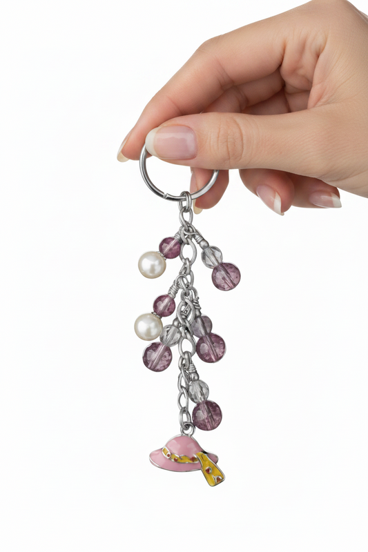 Little Pink Enamel Hat Handmade Beaded Keychain held by a hand showing scale.