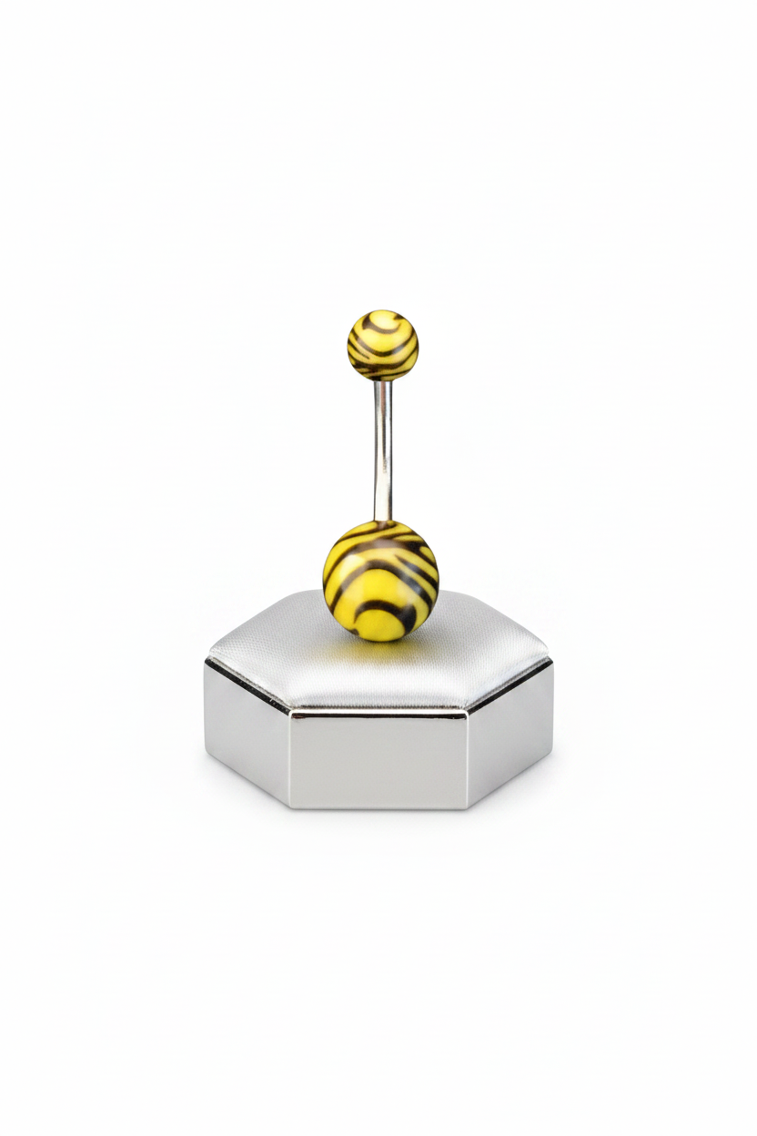 Yellow Tiger Striped Acrylic Belly Button Ring in 316l stainless steel on a silver jewelry display upright position.