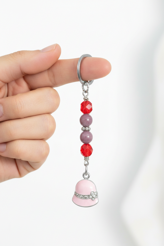 Pink Enamel Hat Handmade Beaded Mini Keychain held by a hand showing scale.
