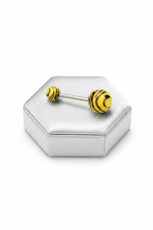 Yellow Tiger Striped Acrylic Belly Button Ring in 316l stainless steel on a silver jewelry display.