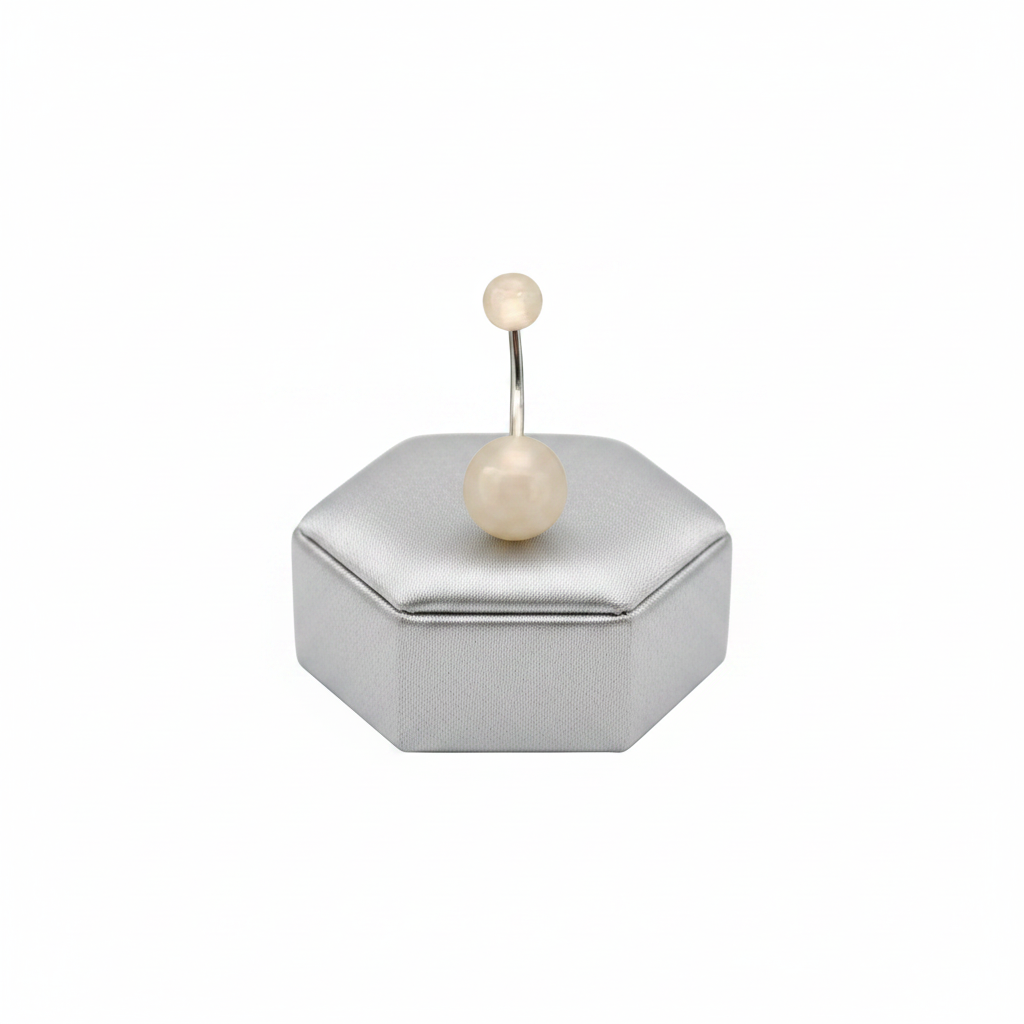 White Glow Acrylic Belly Button Ring in 316l stainless steel on a silver jewelry display.