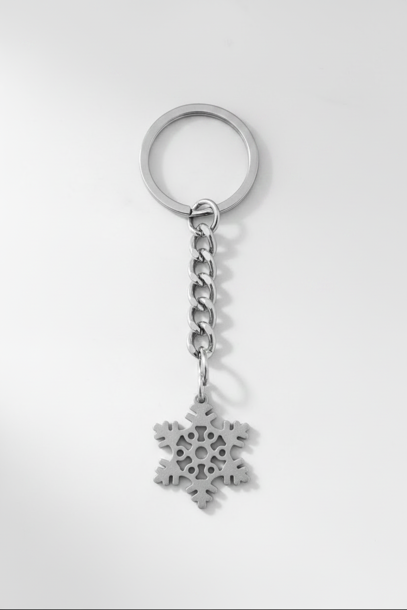 Winter Snowflake Handmade Pewter Charm Keychain on a white background.