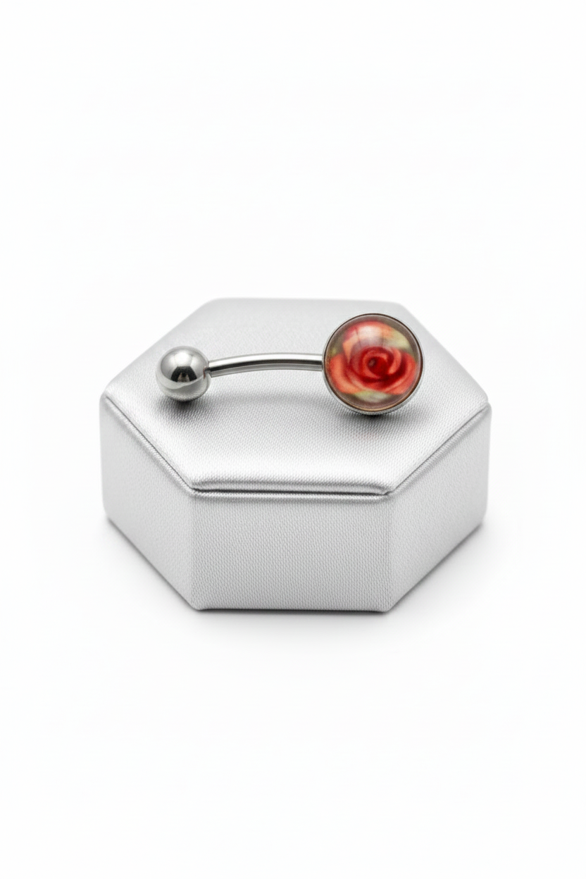 Red Rose Acrylic Belly Button Ring in 316l stainless steel on a silver jewelry display.