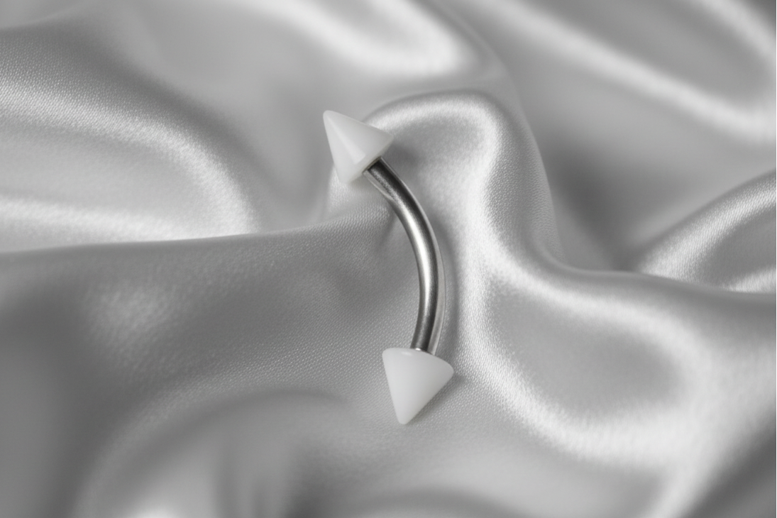 White Glow Acrylic Spike Eyebrow Ring in 316l stainless steel.