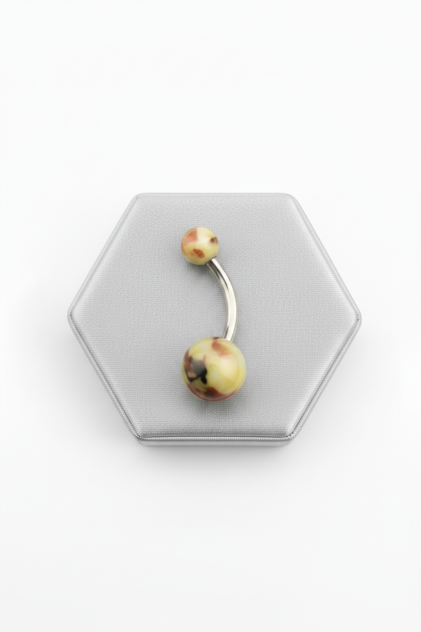Green & Brown Camouflage Acrylic Belly Button Ring in 316l stainless steel on a silver jewelry display.