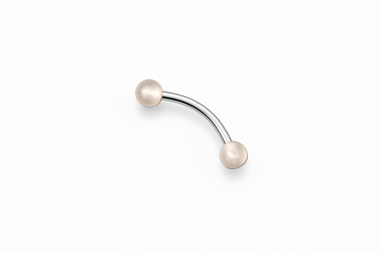 Peach Glow Ball Acrylic Eyebrow Ring in 316l stainless steel angled left.