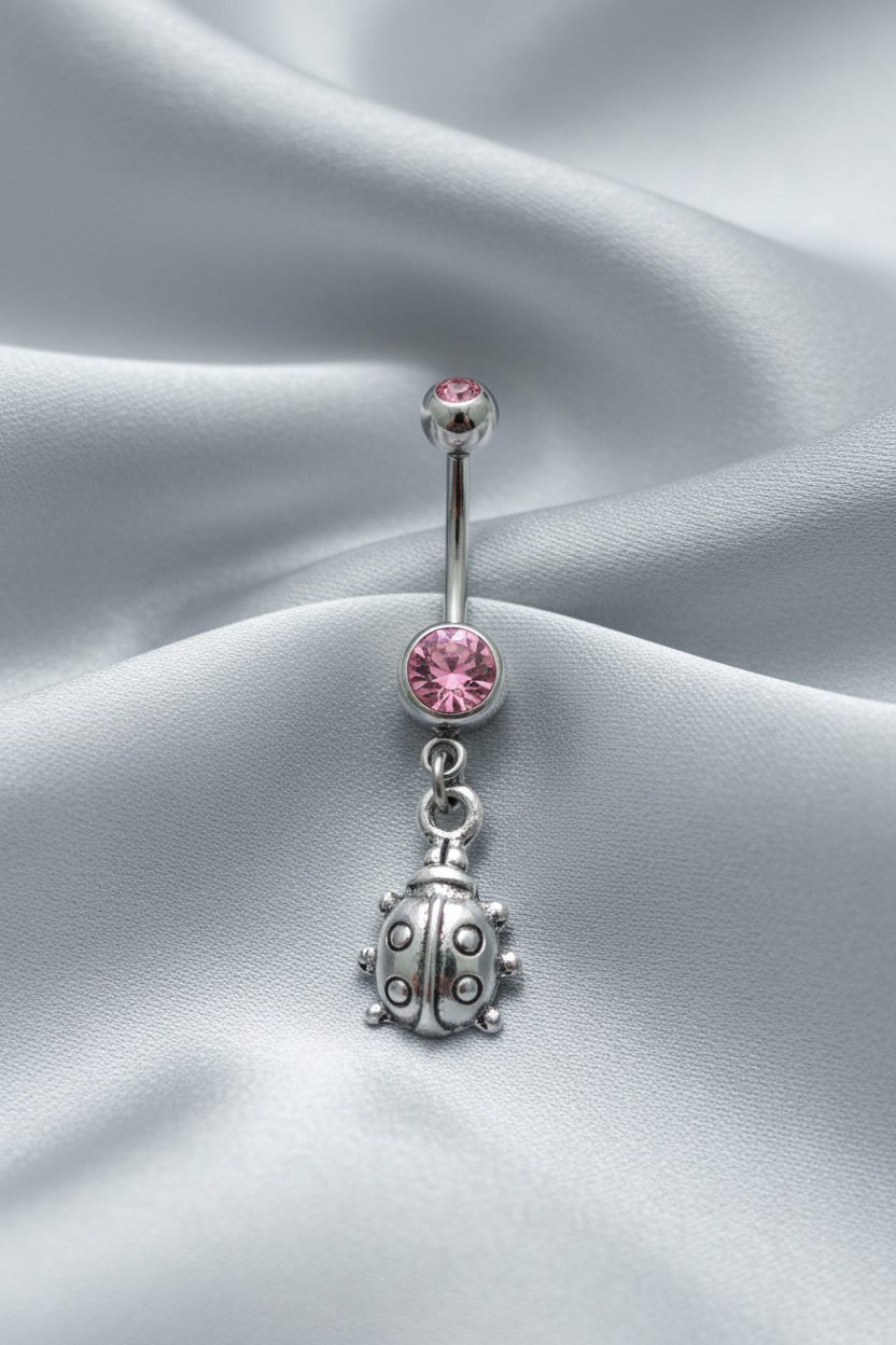 Pink Crystal Lady Bug Belly Button Ring in 316l stainless steel.