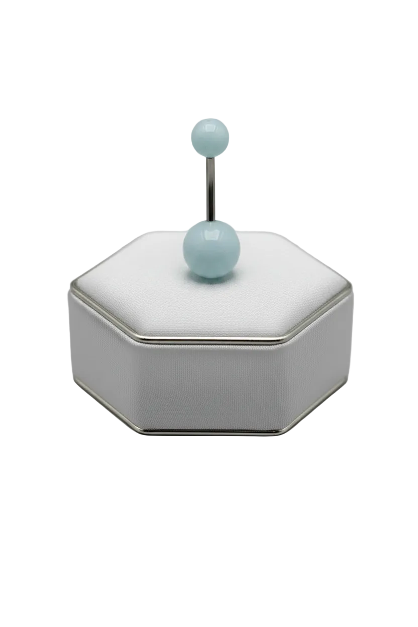Blue Glow Acrylic Belly Button Ring in 316l stainless steel on a silver jewelry display.