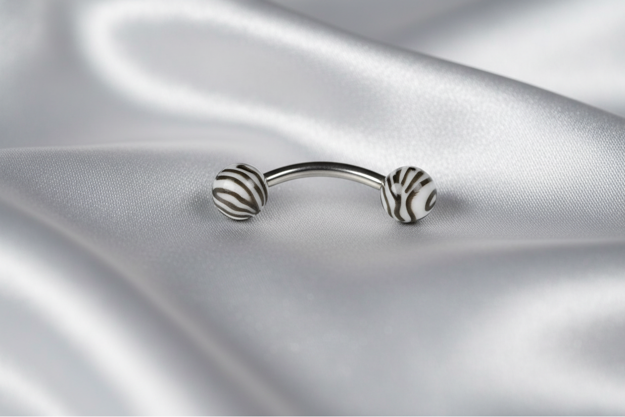 Black and White Tiger Striped Acrylic Eyebrow Ring in 316l stainless steel.