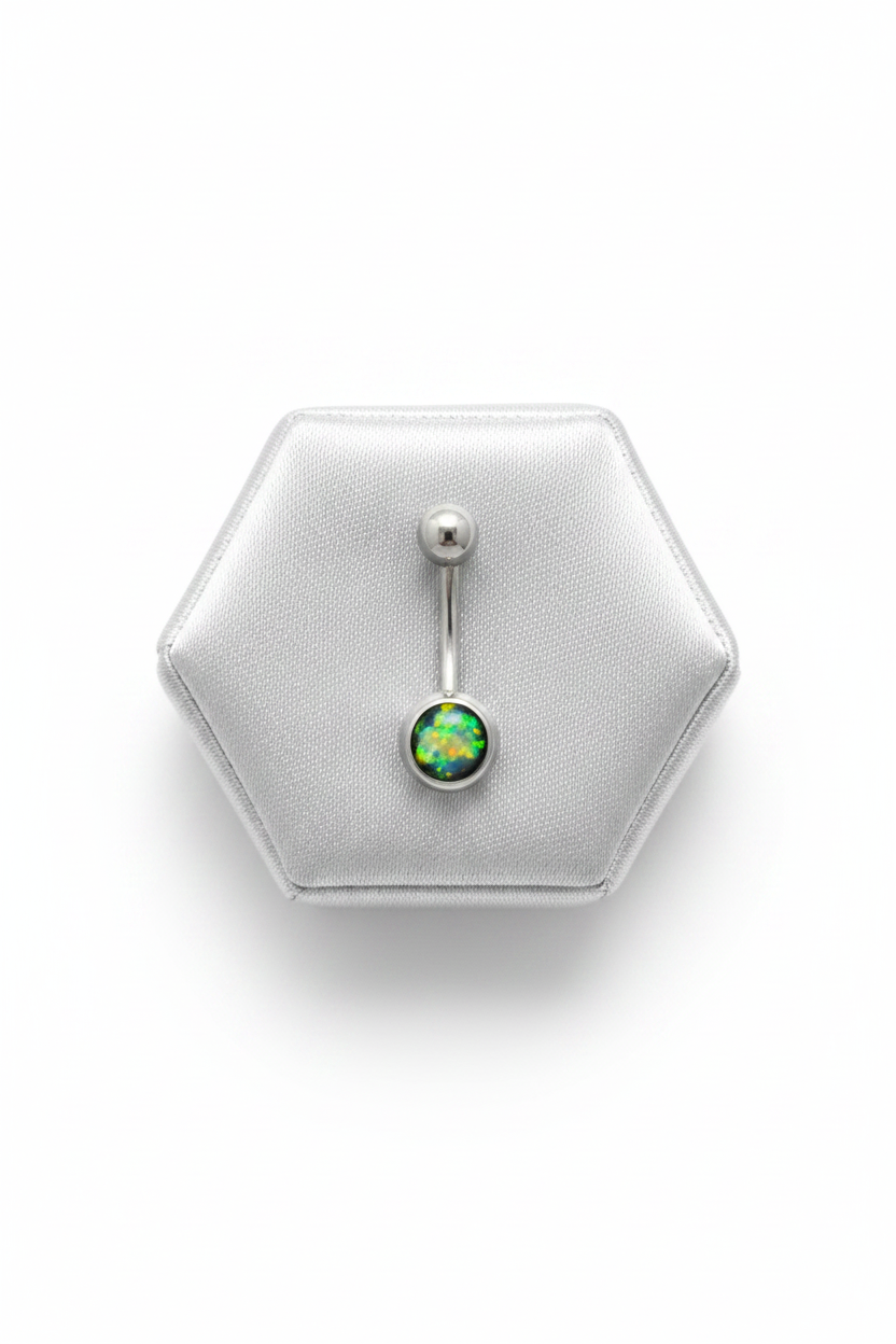 Black Opal Belly Button Ring in 316l stainless steel on a silver silk jewelry display.