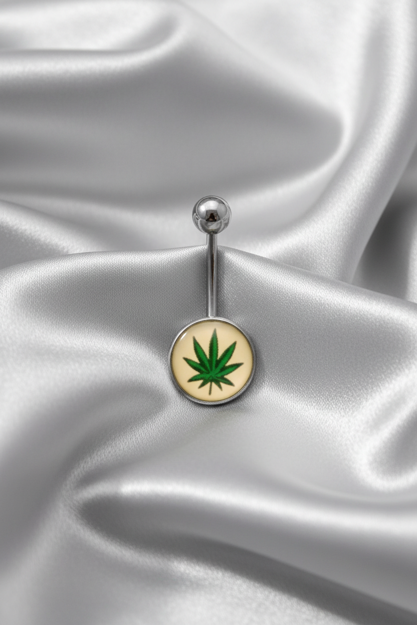 Green Leaf Belly Button Ring in 316l stainless steel on a silver silk fabric.
