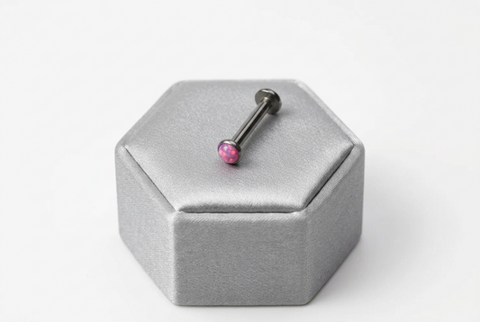 Internally Threaded Fuchsia Pink Opal Labret Lip Ring in 316l stainless steel on a silver silk jewelry display.
