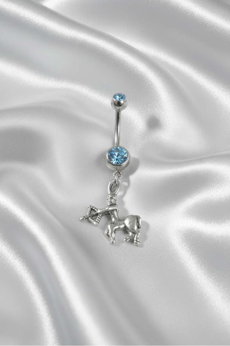 Blue Crystal Sagittarius Belly Button Ring in 316l stainless steel.