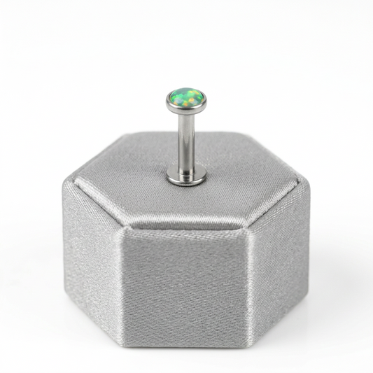 Internally Threaded Green Opal Labret Lip Ring in 316l stainless steel on a silver silk jewelry display.