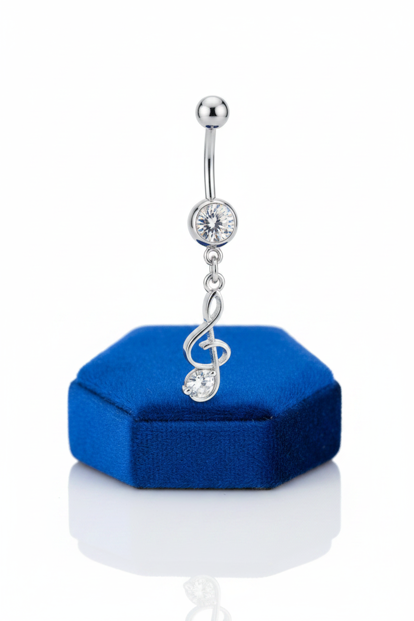 Clear Crystal Treble Clef Belly Button Ring in 316l stainless steel on a blue velvet jewelry display.