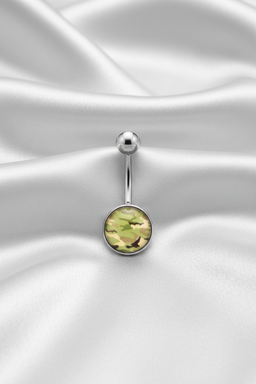 Green Camouflage Belly Button Ring in 316l stainless steel on silver silk fabric.