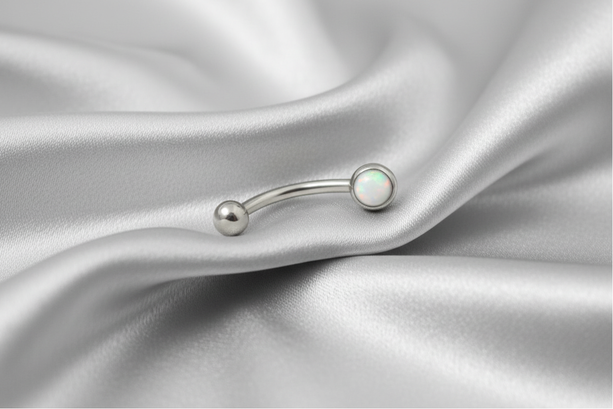 White Opal Flat Head Top Eyebrow Ring in 316l stainless steel.
